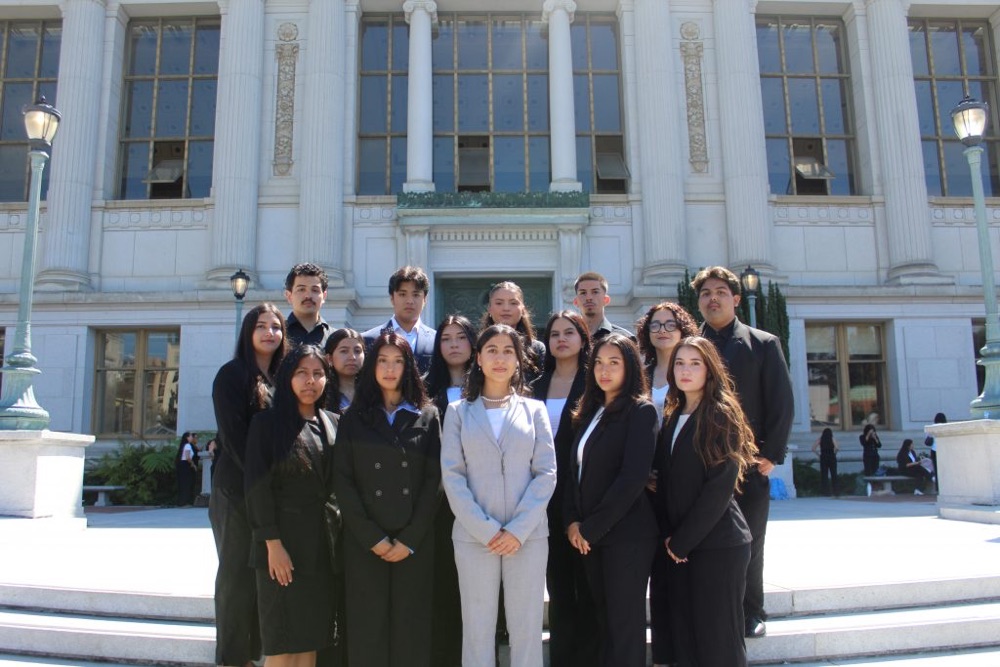 CHE members posing together in formal attire on campus