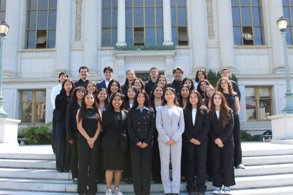 CHE members smiling together on the steps of Doe Library